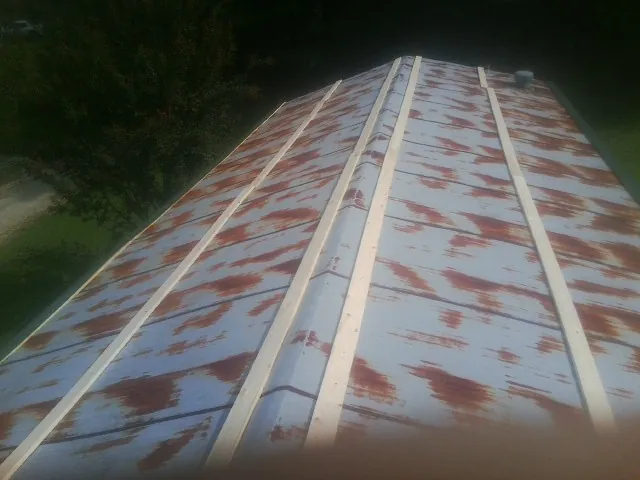Rusted metal roof panels with new wood purlins before replacement — Storm Damage Roof Repair in Hunter by Roofing Brothers