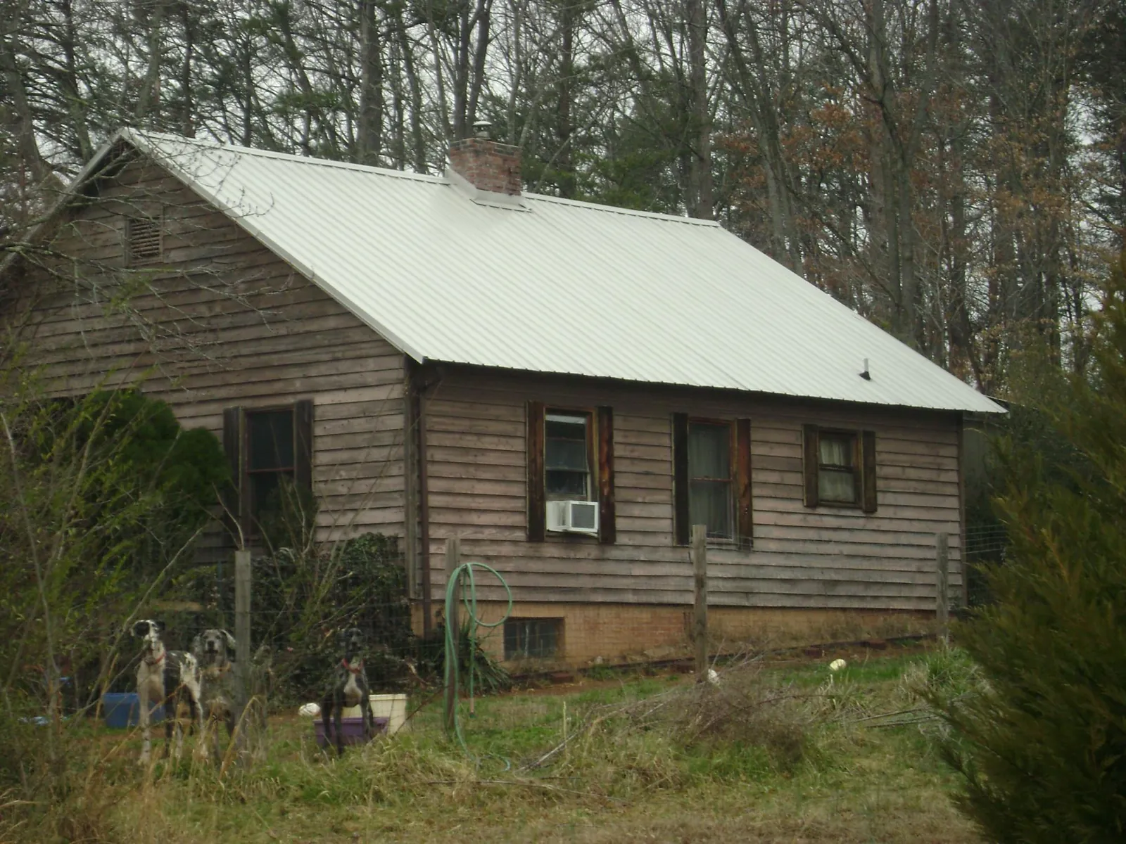 White metal roof on an old wood sided farmhouse, from a Metal Roof Installation job in Hunter